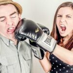 Girl full of aggression punches a man.